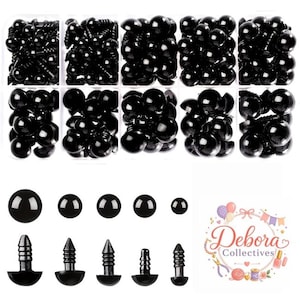 May include: A collection of black plastic safety eyes for crafts, organized in a ten-compartment clear plastic storage box. The set includes various sizes of round, glossy eyes with threaded stems. A logo for Debora Collectives is visible.