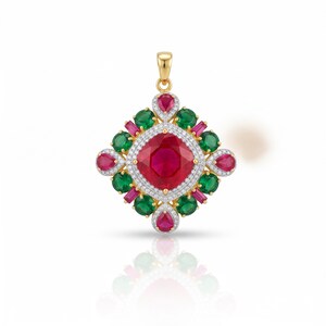 May include: A gold pendant featuring a large cushion-cut red centre stone surrounded by a halo of small white stones. The design includes alternating round green stones and baguette-cut red stones, accented by pear-shaped red stones at the points.