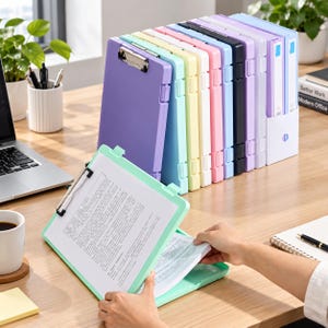 May include: A collection of plastic storage clipboards in various pastel and solid colors, including purple, mint green, yellow, white, pink, black, and blue. Each clipboard features a metal clip at the top and a hinged case for document storage.