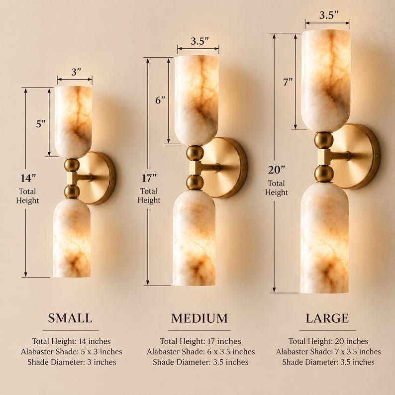 May include: Three wall sconces with cylindrical alabaster shades and brass hardware. The small sconce is 14 inches tall with 5-inch shades. The medium is 17 inches tall with 6-inch shades. The large is 20 inches tall with 7-inch shades.