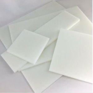May include: A set of five white acrylic sheets in various sizes. The sheets are smooth and opaque.