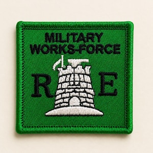 May include: A square embroidered patch with a green background and a dark green border. It features the black text MILITARY WORKS-FORCE above a white stone tower graphic flanked by the black letters R and E, all stitched onto a green fabric base.