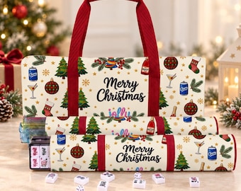 May include: A cream-colored carrying bag and matching storage cases featuring a Christmas pattern with trees, ornaments, stockings, and drinks. The text Merry Christmas is printed on the bag and cases. Several white mahjong tiles and dice are in front.