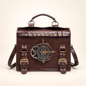May include: A dark brown rectangular handbag featuring a prominent circular clock face on the front centre with visible gears. The bag includes a top handle, two vertical straps with brass-toned buckles, and a row of decorative metal studs along the top.