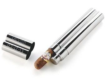 May include: A silver cigar tube with a personalized inscription that reads "Devon 05-17-13". The tube is open and a brown cigar is partially inserted.