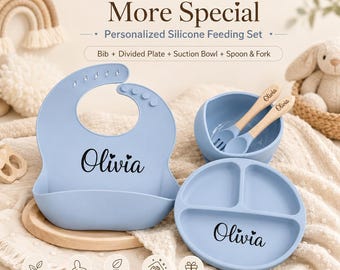 May include: A light blue silicone feeding set featuring a bib, a divided plate, a suction bowl, and a spoon and fork with wooden handles. Each item is personalized with the name Olivia. The text Make Mealtime More Special is visible.