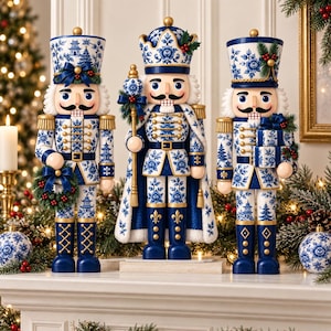 May include: Three nutcracker figures decorated in a blue and white floral pattern. The left figure holds a wreath, the center figure wears a crown and holds a staff, and the right figure holds a stack of gifts. All feature gold accents and black mustaches.