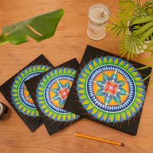 May include: Three black notebooks with colorful mandala designs on the covers. The mandalas feature blue, green, yellow, orange, and red colors.