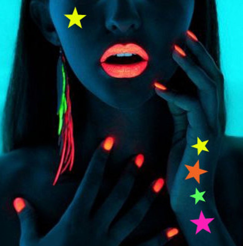 glowing blacklight star stickers on woman face