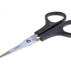 May include: Black handled scissors with a silver blade. The blade is labeled "FINNY".