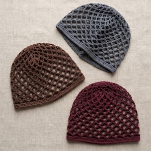 May include: Three crochet mesh caps in brown, grey, and dark red, each featuring a diamond-shaped openwork pattern and a solid brim. The text Crochet Brown Mesh Cap Pattern and Instant PDF Download is displayed at the top and bottom of the image.