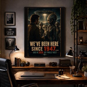 May include: A rectangular wall poster featuring a human and an extraterrestrial figure shaking hands under a flying saucer. The text reads: WE'VE BEEN HERE SINCE 1947... AND IN 2026, WE FINALLY MEET. The artwork uses dark, moody tones with a glowing light.