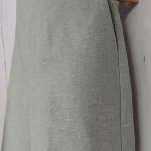 May include: A pair of light green linen pants with a straight leg and a simple design.