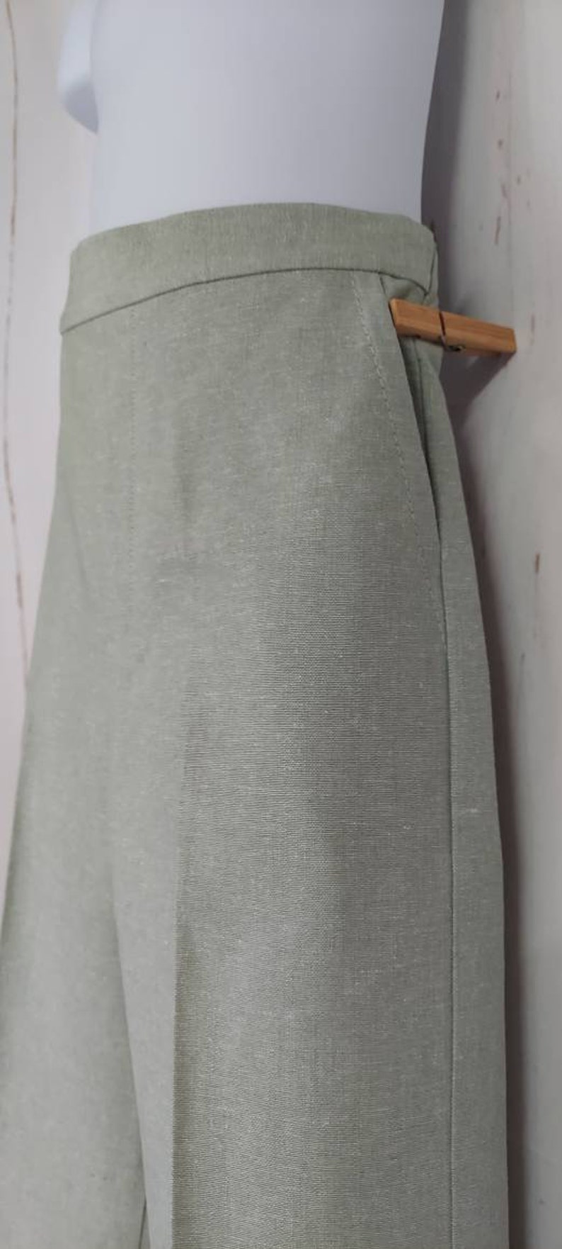 May include: A pair of light green linen pants with a straight leg and a simple design.