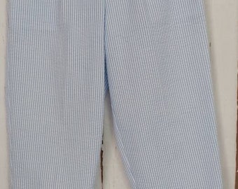 May include: Blue and white striped cotton shorts with a pleated front.