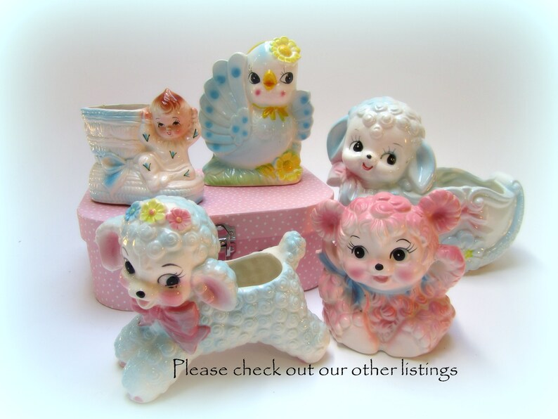 May include: A set of vintage ceramic planters featuring a blue bird, a baby in a shoe, a lamb, and a pink lamb. The planters are all in pastel colors and have a whimsical design.