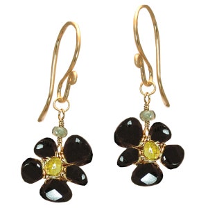 May include: A pair of gold dangle earrings with black and yellow gemstone flower accents.