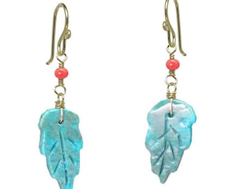 May include: A pair of turquoise leaf earrings with gold wire and a single red bead on each earring.