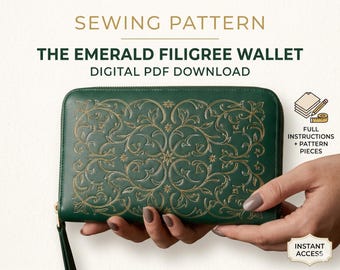 May include: A digital sewing pattern for The Emerald Filigree Wallet. The image shows a dark green rectangular wallet with a gold filigree pattern, a zipper closure, and a wrist strap. Text includes SEWING PATTERN, THE EMERALD FILIGREE WALLET, DIGITAL PDF DOWNLOAD, FULL INSTRUCTIONS + PATTERN PIECES, and INSTANT ACCESS.