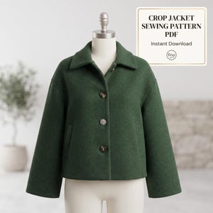 May include: A dark green crop jacket with a wide collar, long sleeves, and three brown buttons down the front. The text CROP JACKET SEWING PATTERN PDF Instant Download is displayed in a white box in the upper right corner of the image.