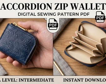 May include: An accordion zip wallet digital sewing pattern PDF. The wallet is dark blue with an embossed floral pattern on the exterior and a light beige interior with multiple card slots. The design features a gold-tone zipper closure.