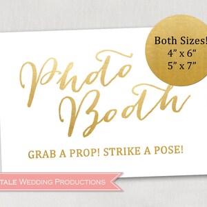 May include: White sign with gold lettering that says "Photo Booth" and "Grab a Prop! Strike a Pose!"  The sign also has a gold circle with the text "Both Sizes! 4" x 6" 5" x 7" ".