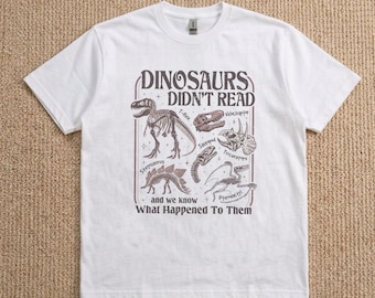 Graphictee Dinosaurs Didn't Read, camiseta unisex de algodón, camiseta, ropa urbana, camiseta para enseñar.