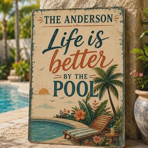 May include: A rectangular metal sign with a distressed cream background featuring the text THE ANDERSON Life is better BY THE POOL. The design includes a graphic of a swimming pool, a wooden lounge chair, a palm tree, and tropical flowers.
