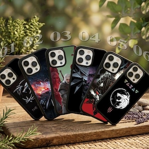 May include: Six black smartphone cases arranged in a row, each featuring distinct graphic designs including character illustrations, a wolf emblem, and geometric symbols. The cases are numbered 01 through 06 in a light, semi-transparent font.
