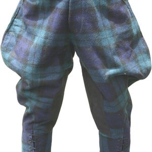 May include: Tartan breeches featuring a blue and teal plaid pattern with a high-waisted fit, flared hip sections, and solid black knee patches. The lower legs include black fabric cuffs with vertical button closures and integrated lace-up detailing.
