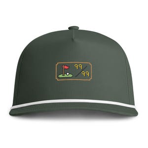 May include: A dark olive green baseball cap with a white cord trim along the base of the crown. The front features a pixel art graphic of a golf green with a red flag, a white golf ball, and the yellow text 99/99 inside a rectangular border.