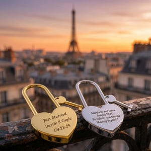 May include: Two heart-shaped padlocks, one gold and one silver, each with a matching key. The gold lock is engraved with Just Married, Dustin & Cayla, 09.28.24. The silver lock is engraved with Marybeth and Ioana, Prague 2024, To infinity and beyond, Missing beyond.