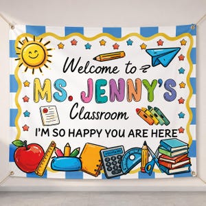 May include: A rectangular classroom banner with a blue and white striped border, featuring a yellow sun, a blue paper airplane, and school supplies. Text reads: Welcome to MS. JENNY'S Classroom I'M SO HAPPY YOU ARE HERE, surrounded by colourful stars.