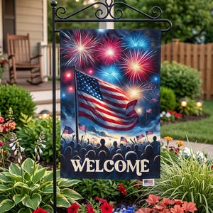 A patriotic welcome sign featuring an American flag and fireworks is displayed in a garden setting with colorful flowers and greenery.
