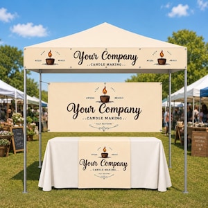 May include: A cream-colored pop-up canopy tent featuring a large banner and table runner. The branding displays the text Your Company Candle Making, a candle icon with a flame, and the codes #FEDO and #B4513 printed in dark brown ink.