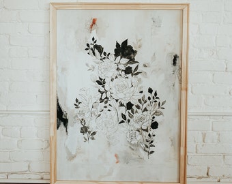 May include: A framed black and white floral print with a light beige background. The flowers are stylized and have a delicate, almost watercolor-like appearance.