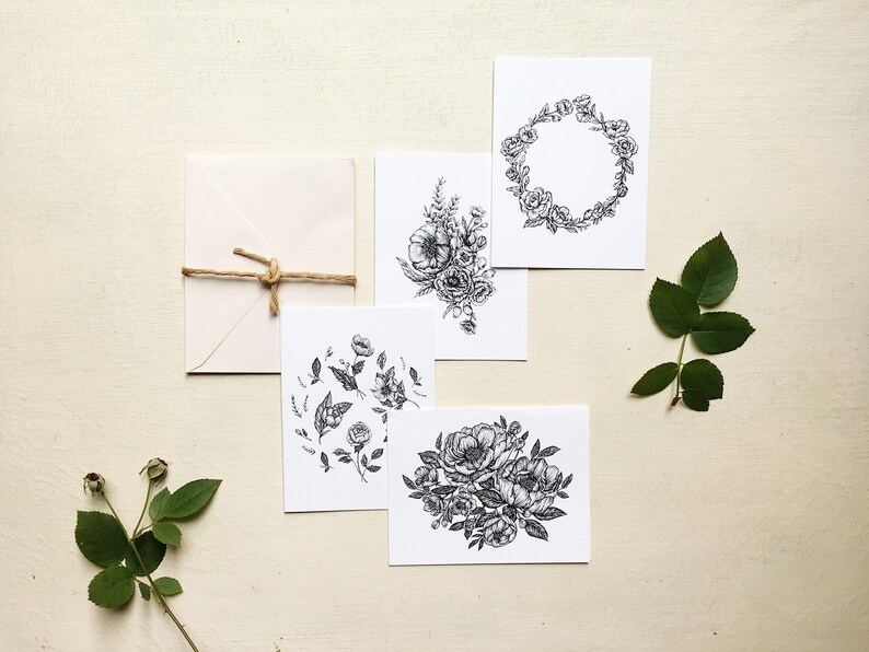 May include: Five black and white floral illustrations printed on white card stock. The illustrations feature different floral arrangements, including a wreath, a bouquet, and a single flower.