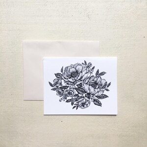 May include: A black and white illustration of a bouquet of flowers. The flowers are drawn in a realistic style and have a delicate, feminine feel.