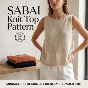 May include: A sleeveless beige knit top with a boat neckline. The text SABAI Knit Top Pattern is visible along with a digital PDF icon. Two folded knit tops in rust orange and black are stacked on a wooden surface below the text.