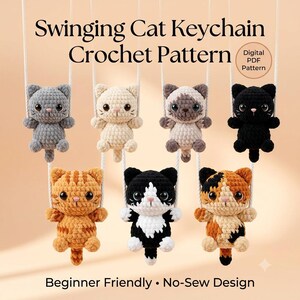 May include: A digital PDF crochet pattern for a Swinging Cat Keychain. The image displays seven small, crocheted cats in various colors including gray, cream, Siamese, black, orange tabby, black and white, and calico, each hanging from white ropes.