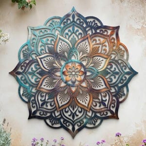 May include: A circular wall art piece featuring a symmetrical mandala pattern with intricate cutouts. The design displays a gradient of colors transitioning from deep blue and teal at the outer edges to warm copper and gold tones in the center.