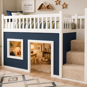 May include: A white loft bed with a dark blue base, featuring a built-in play area underneath, a square window, and a set of three carpeted stairs on the side. The top bunk has a white railing and a mattress with a striped blue, green, and white cover.