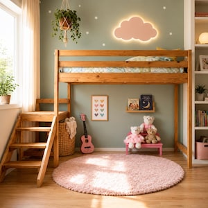 May include: A wooden loft bed with an integrated staircase, positioned over a play area featuring a pink circular rug, a pink toy guitar, a small pink bench with three teddy bears, a wall-mounted cloud light, and a framed heart print.