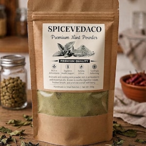 May include: A brown kraft paper stand-up pouch containing green mint powder. The label reads SPICEVEDACO Premium Mint Powder, Premium Quality, Net Wt 200g, and lists benefits including digestive health support, antioxidants, and cooling properties.