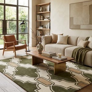 May include: A rectangular area rug featuring a geometric pattern in olive green, cream, and tan. The design consists of interlocking quatrefoil shapes and rectangular blocks, creating a structured, repeating motif across the entire surface.