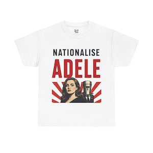 May include: A white short-sleeve t-shirt featuring a graphic print with the text NATIONALISE ADELE in black and red. The design includes an illustration of a woman with long brown hair next to a figure wearing a metal bucket helmet over a suit.