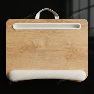 May include: A rectangular lap desk with a light oak wood grain finish, featuring a white plastic slot for tablets or phones at the top, a white fabric-covered wrist rest at the bottom, and a white fabric carrying handle attached to the top edge.
