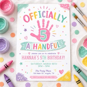 May include: A rectangular birthday invitation card featuring the text "OFFICIALLY A HANDFUL" in colourful letters, a pink handprint with the number "5" in the centre, and details for Hannah's 5th birthday on Saturday, 16th March, at The Party Place.