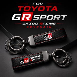 May include: Two black carbon fibre textured keychains with red stitching and gunmetal hardware. One features the GR SPORT logo, the other displays the Gazoo Racing logo. The text FOR TOYOTA GR SPORT GAZOO RACING KEYCHAIN is visible above the items.