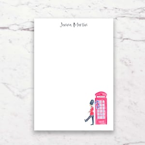 May include: White stationery with the name "Jenna Martin" in script. A watercolor illustration of a red telephone booth and a marching British guard with a Union Jack flag is in the lower right corner.